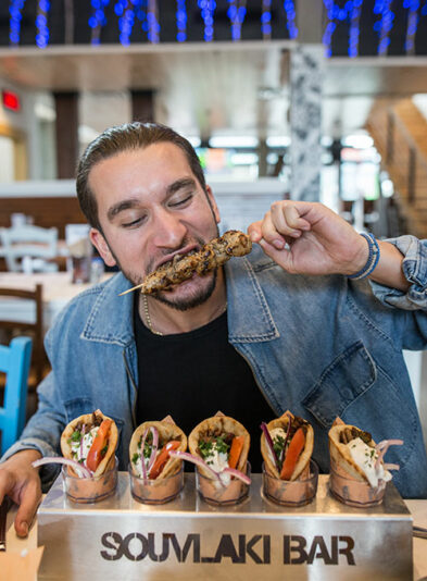 Client taking a big bite of his brochette