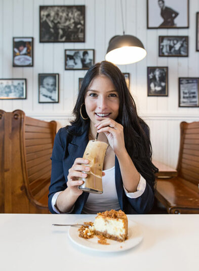 Girl tasting her dessert drink with a custard