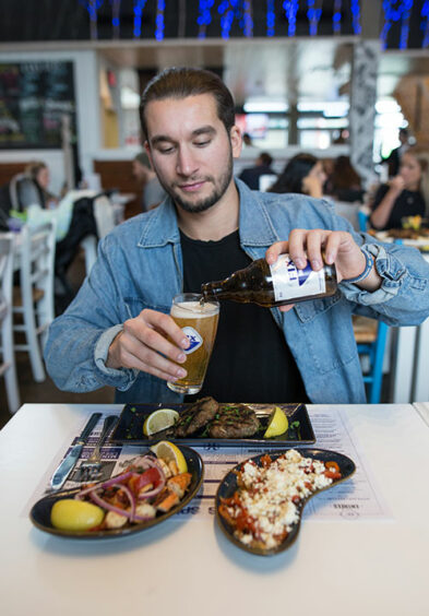 Blue coat client serving himself a beer