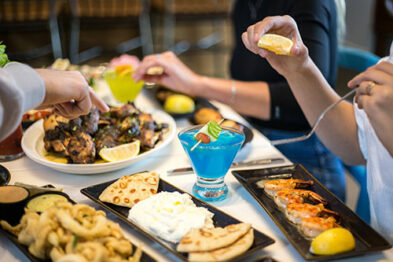 Lots of Souvlaki bar plates on a table